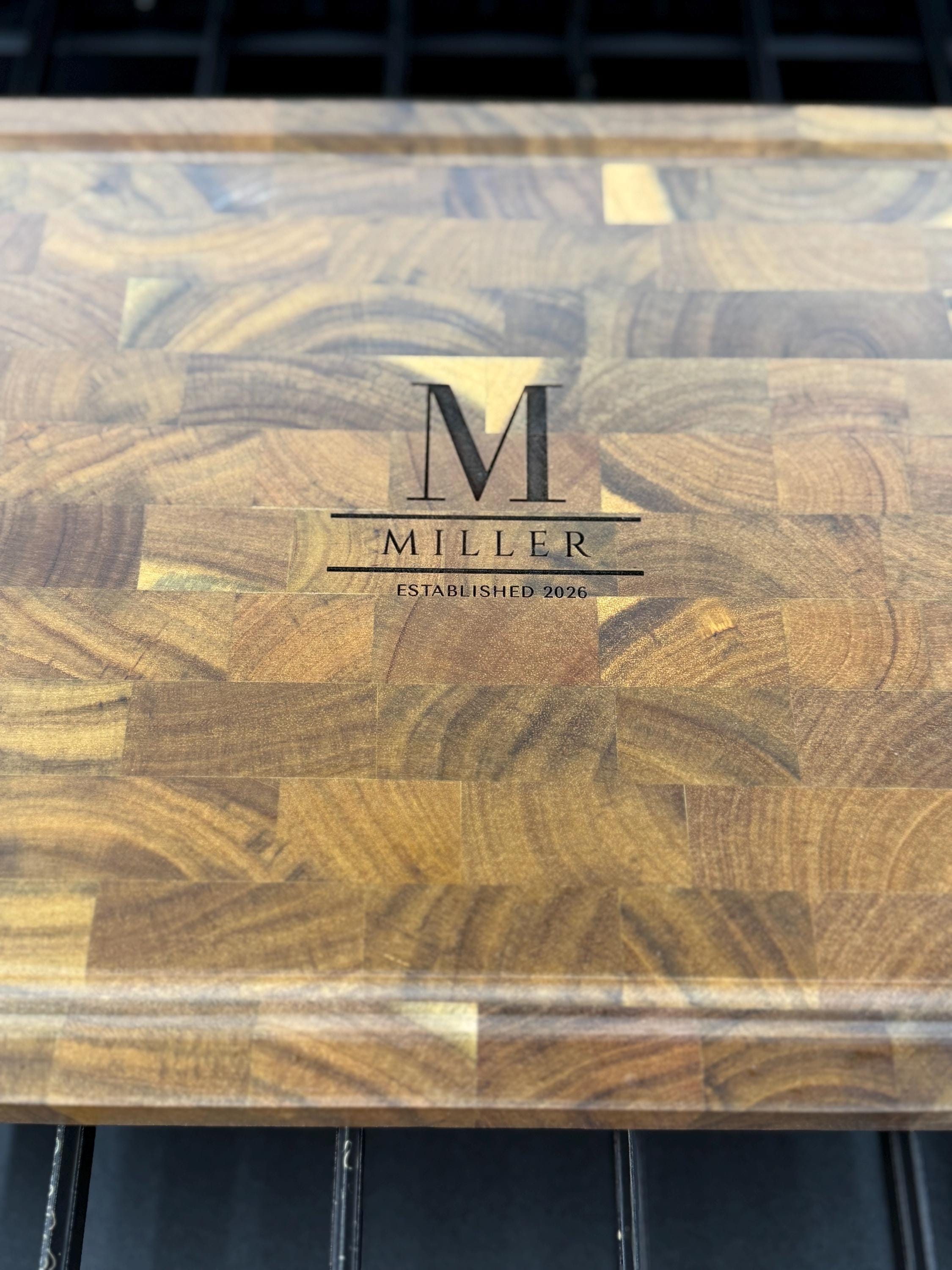 Wooden cutting board with 'Miller' branding on a dark background